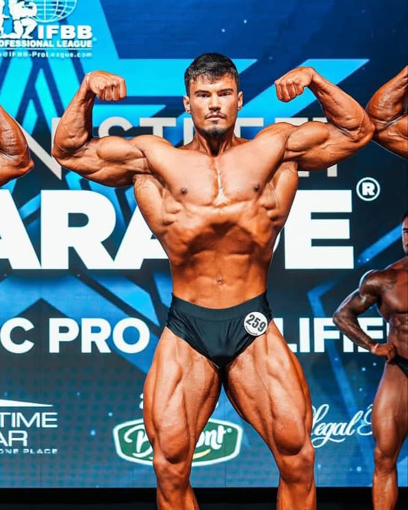 Leo competing on stage at the Fit Parade Pro Qualifier